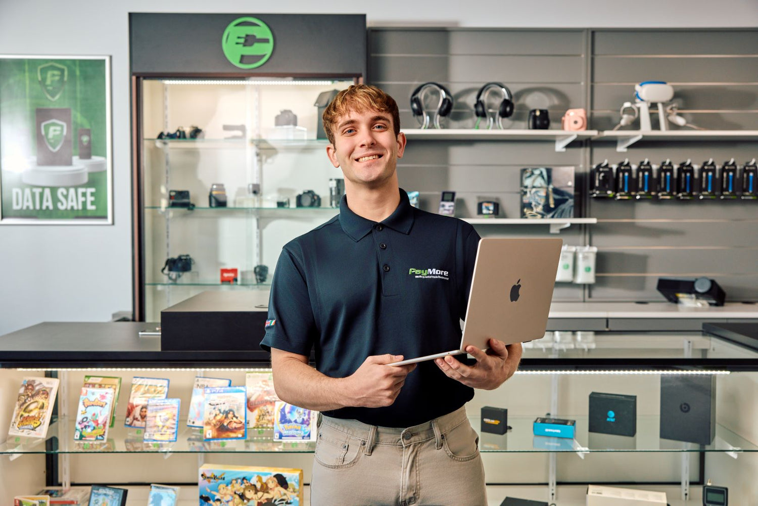 PayMore employee holding a MacBook